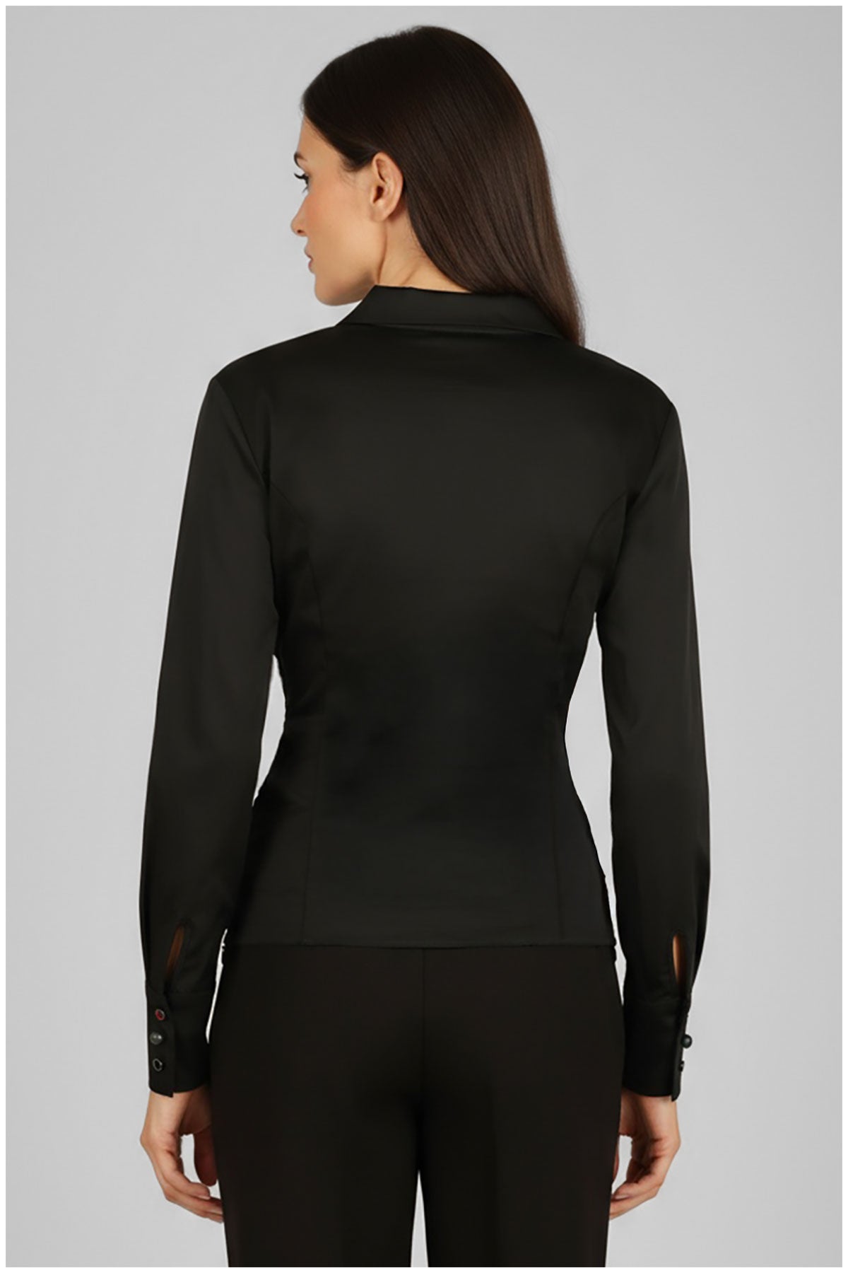 Person wearing a black long-sleeve top on a gray background