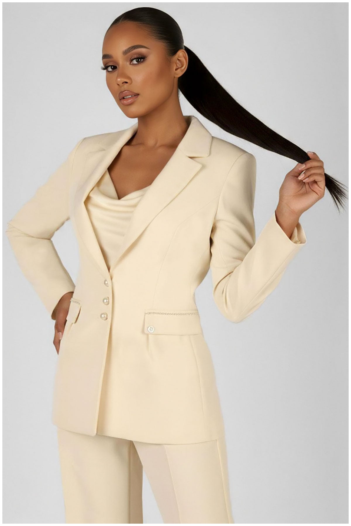 Woman wearing a beige suit with a plain background