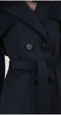 Close-up of a dark blue coat with buttons on a plain background