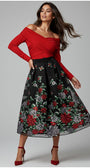 Woman wearing a red off-shoulder Luna Fashion House top and black floral skirt on a gray background
