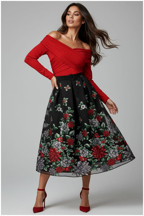 Woman wearing a red off-shoulder Luna Fashion House top and black floral skirt on a gray background
