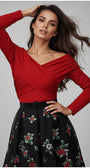 Woman wearing a red Luna Fashion House top and black floral skirt against a gray background
