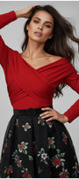 Woman wearing a red Luna Fashion House top and black floral skirt against a gray background