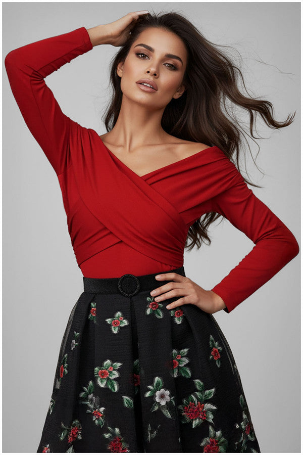 Woman wearing a red Luna Fashion House top and black floral skirt against a gray background