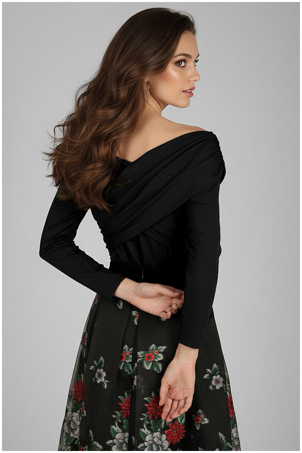 Woman wearing a Luna Fashion House black dress with floral pattern on a gray background