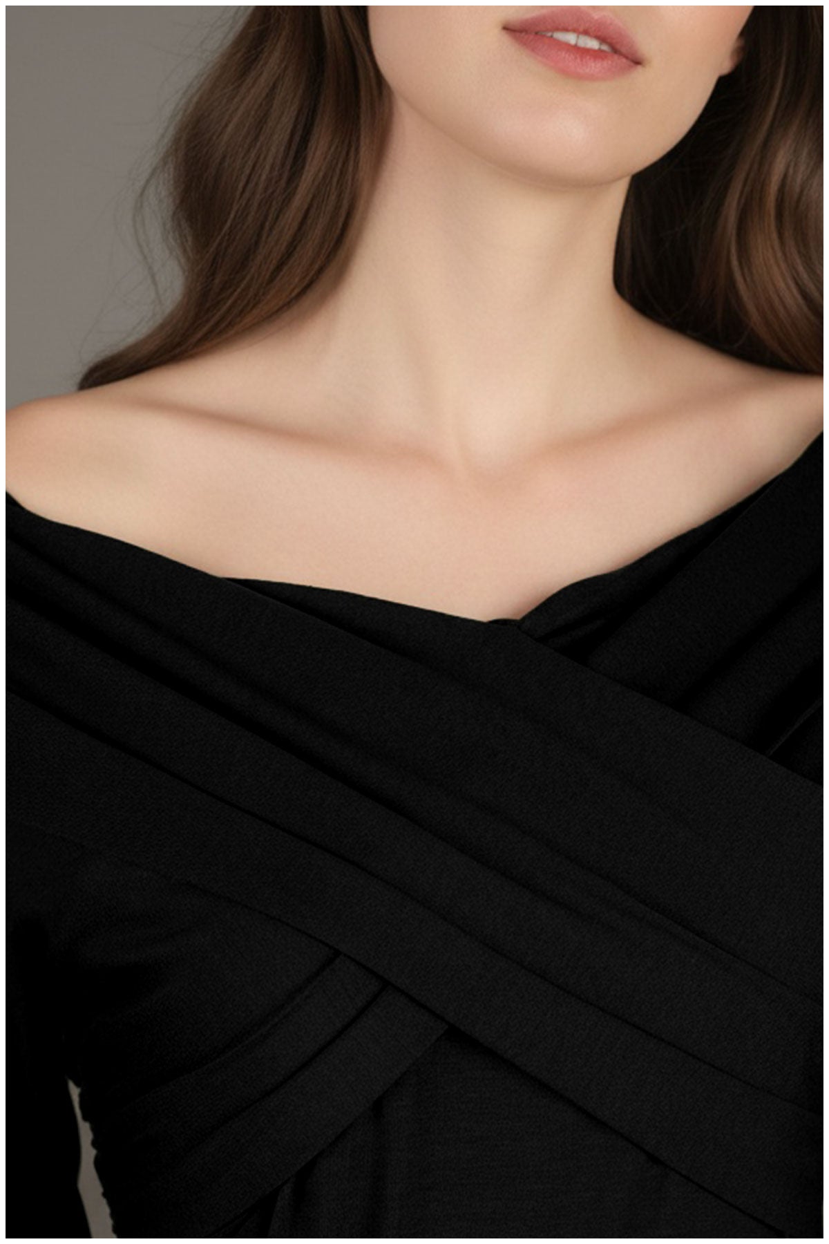 Close-up of a person wearing a black Luna Fashion House off-shoulder top with a neutral background