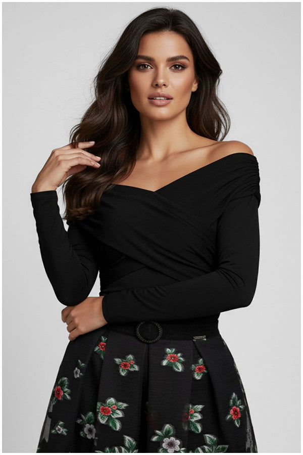 Woman wearing a black off-shoulder Luna Fashion House top with floral skirt on a light gray background