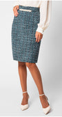 Person wearing a blue patterned skirt on a light gray background