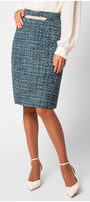 Person wearing a blue patterned skirt on a light gray background