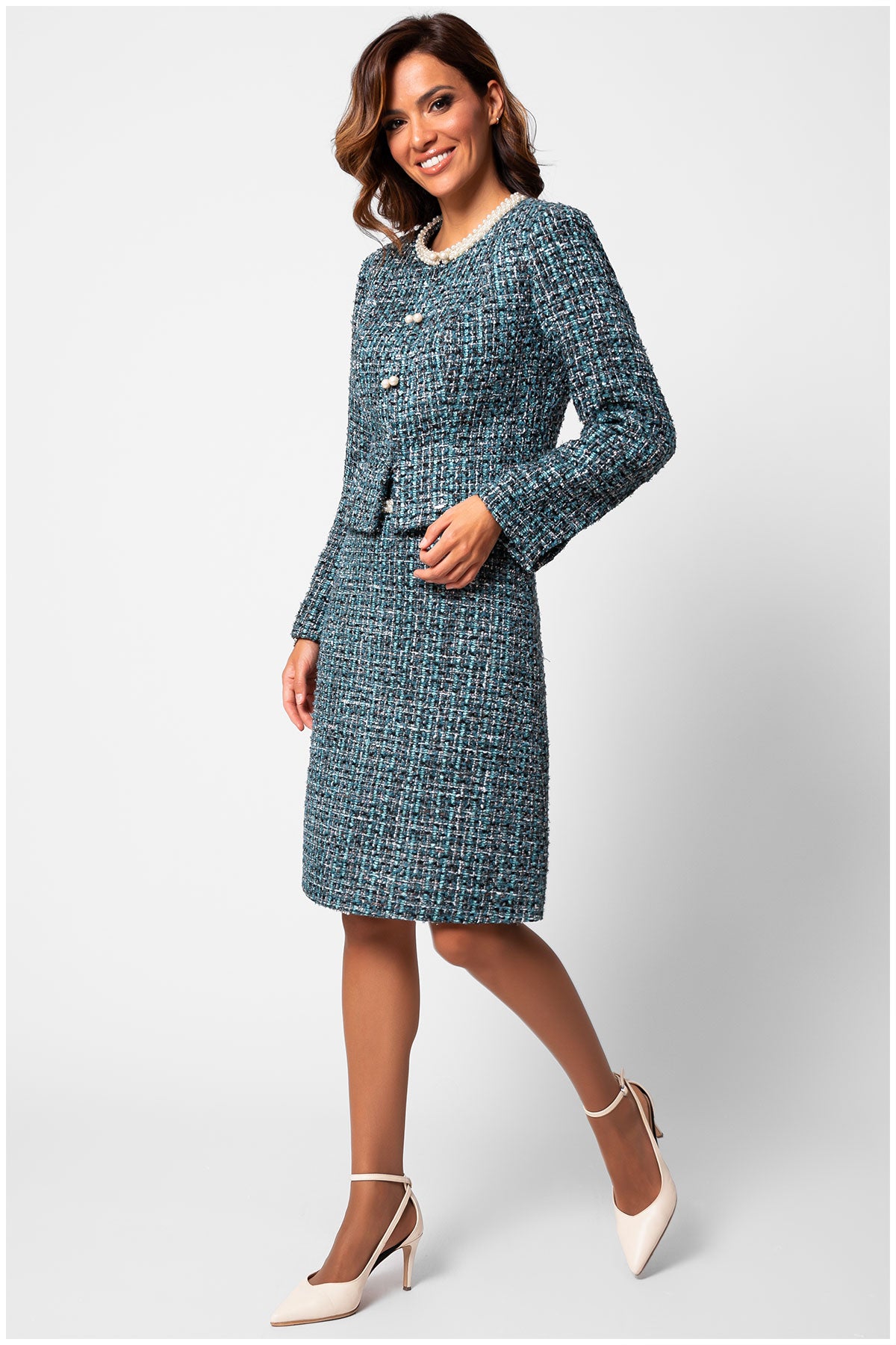 Woman wearing a blue tweed suit on a white background