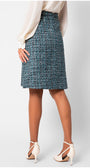 Person wearing a blue tweed skirt on a white background