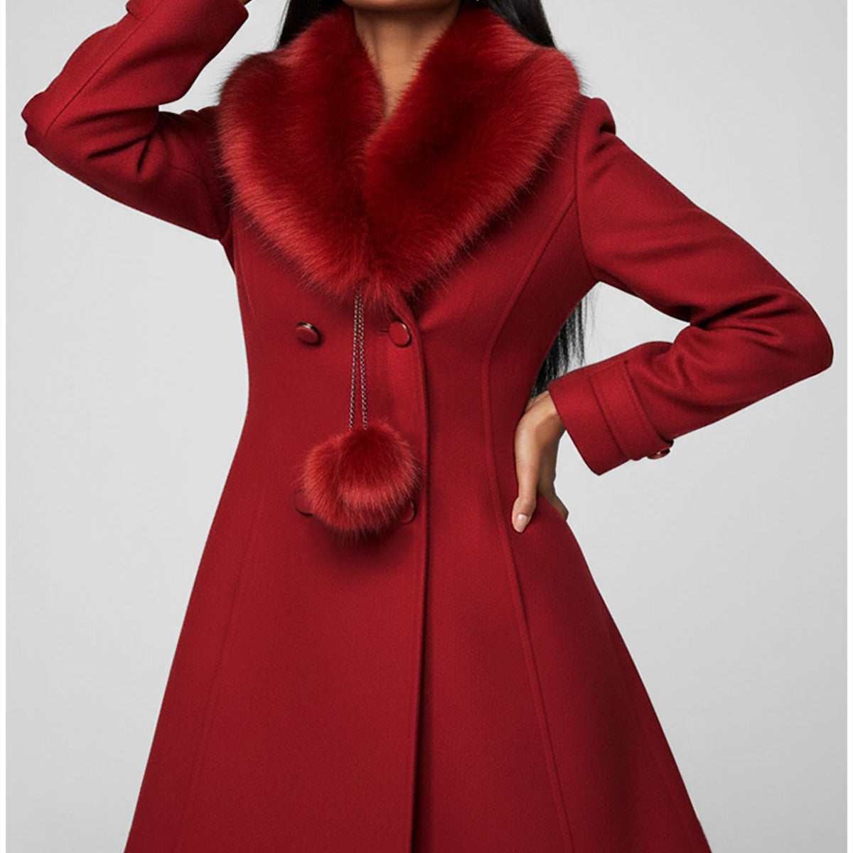 Red coat with fur collar worn by a model on a gray background