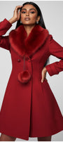 Red coat with fur collar worn by a model on a gray background