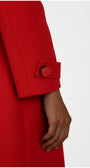 Red coat with a button on a white background