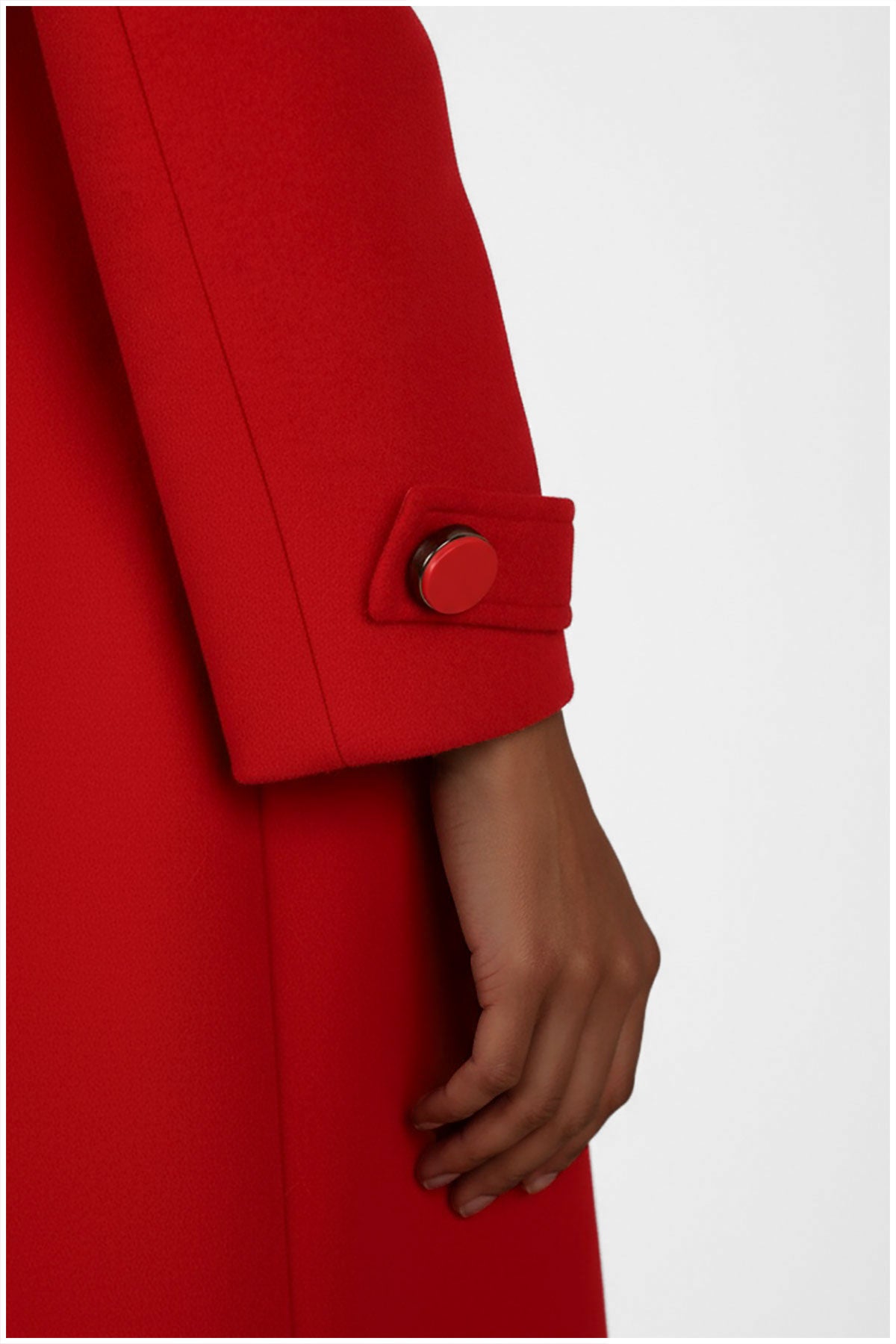 Red coat with a button on a white background