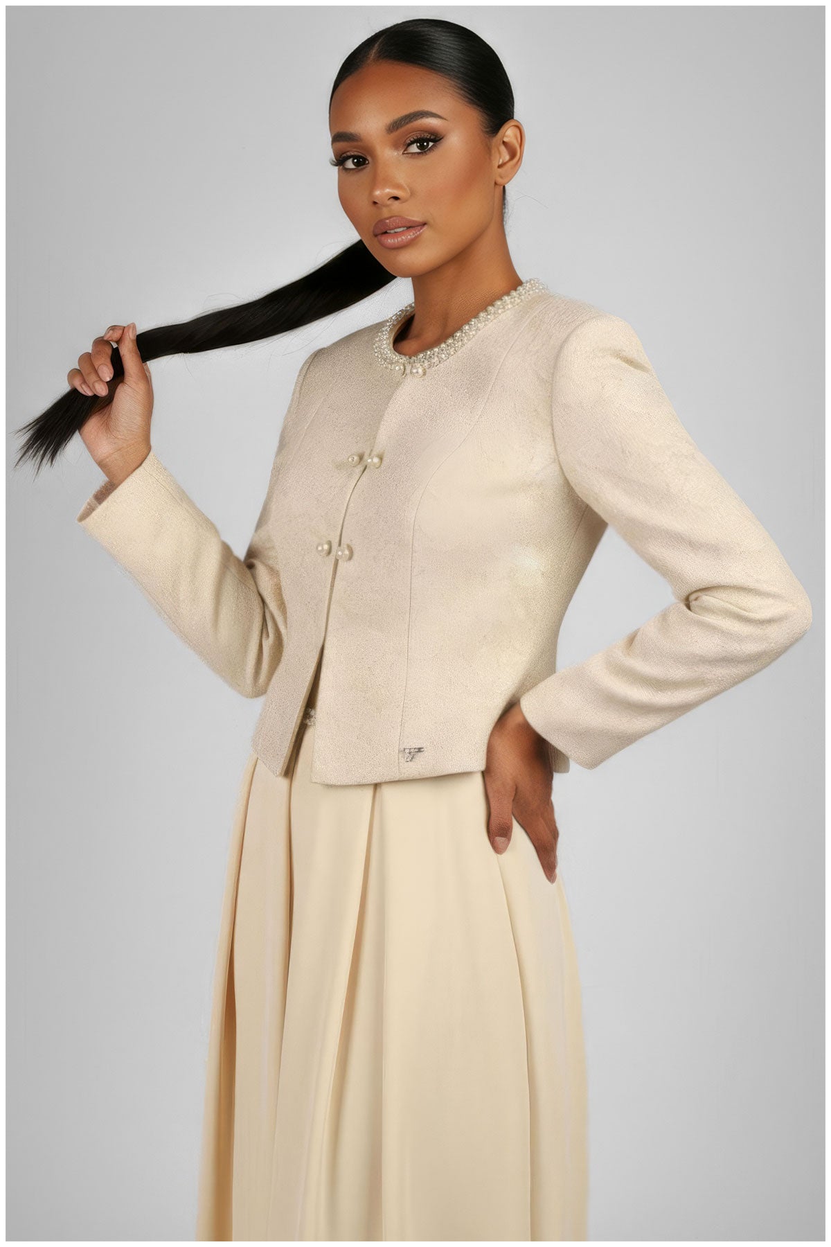Woman wearing a beige suit with a plain background