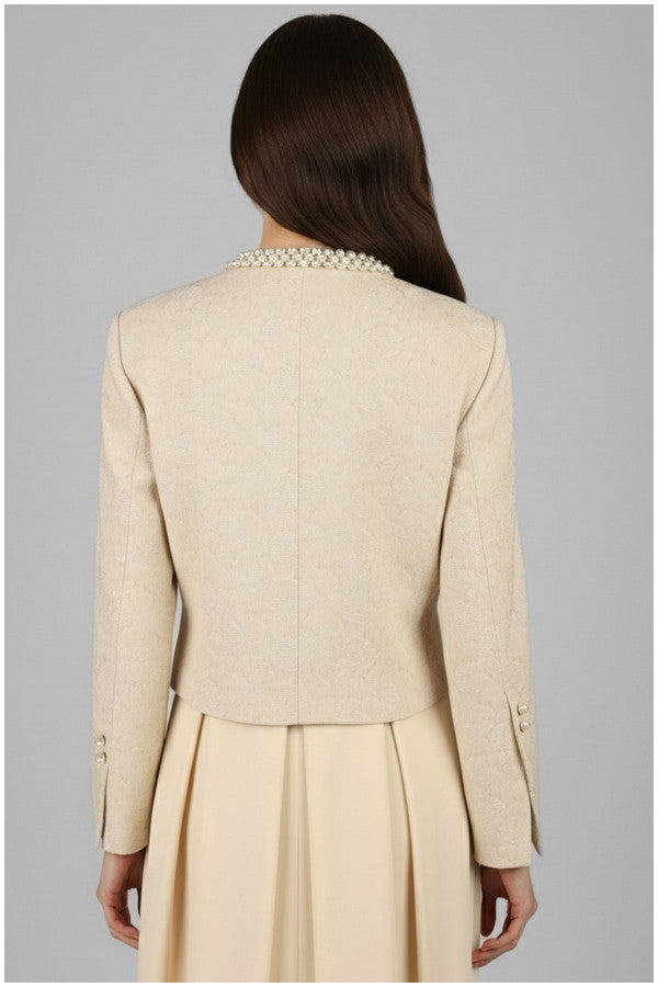 Beige Luna Fashion House suit jacket and skirt worn by a person on a gray background