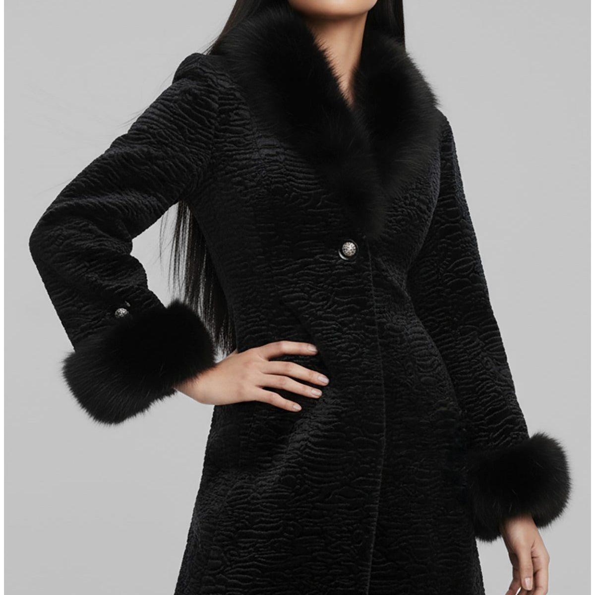 Woman wearing a black coat with fur trim on a gray background
