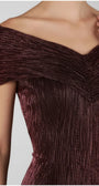Close view of the bordeaux gown's folded off-shoulder neckline and fine vertical metallic texture