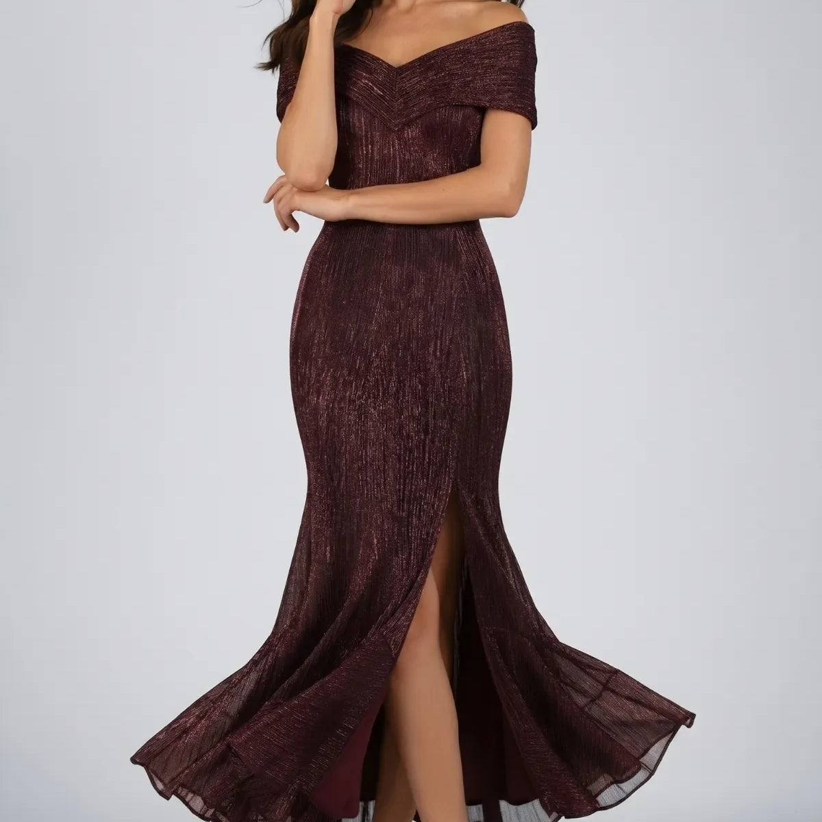 Burgundy Off-Shoulder Metallic Gown, Alis. Folded off-shoulder band with a V at the front, fitted bodice, front slit, and a flared fishtail hem at the ankle.