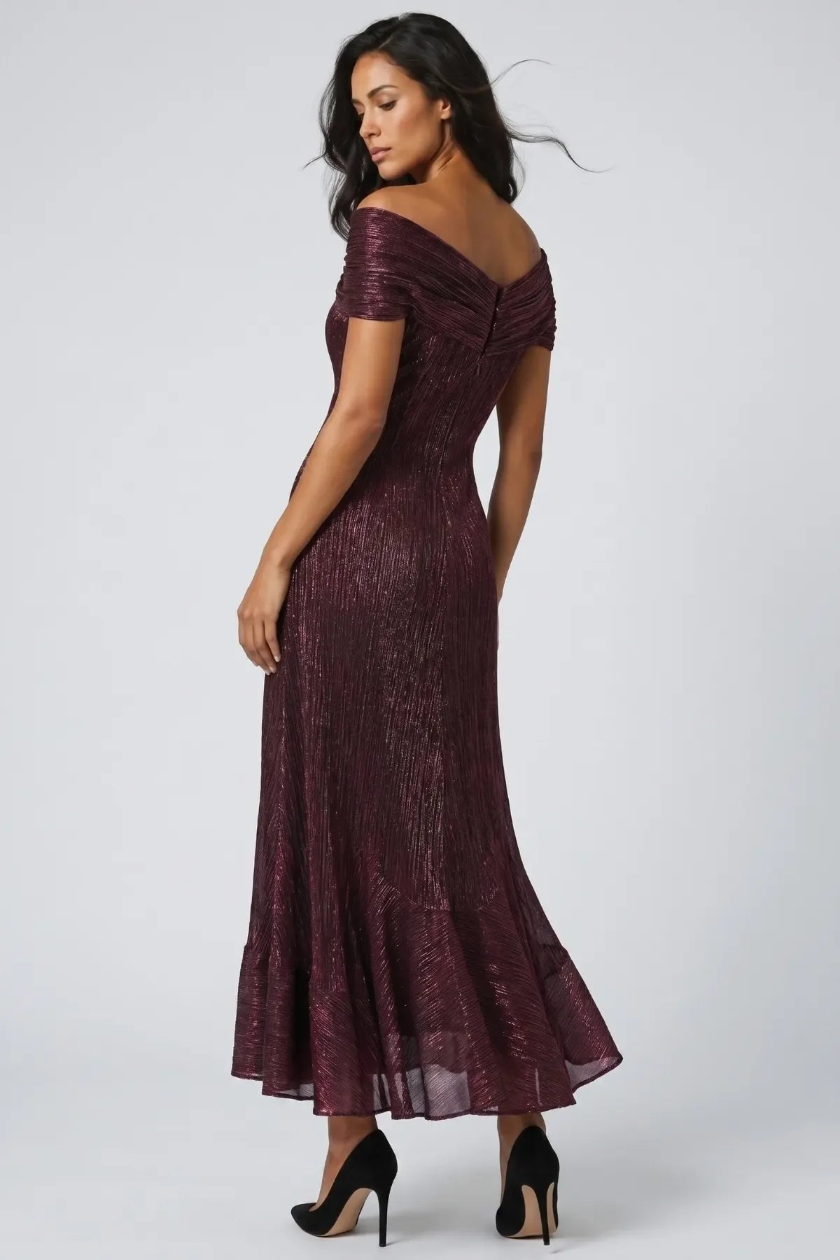 Back of the bordeaux off-shoulder metallic gown showing fitted body, center-back zipper and flared fishtail hem