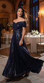 Navy off-shoulder metallic gown with flowing skirt in a candlelit ballroom setting