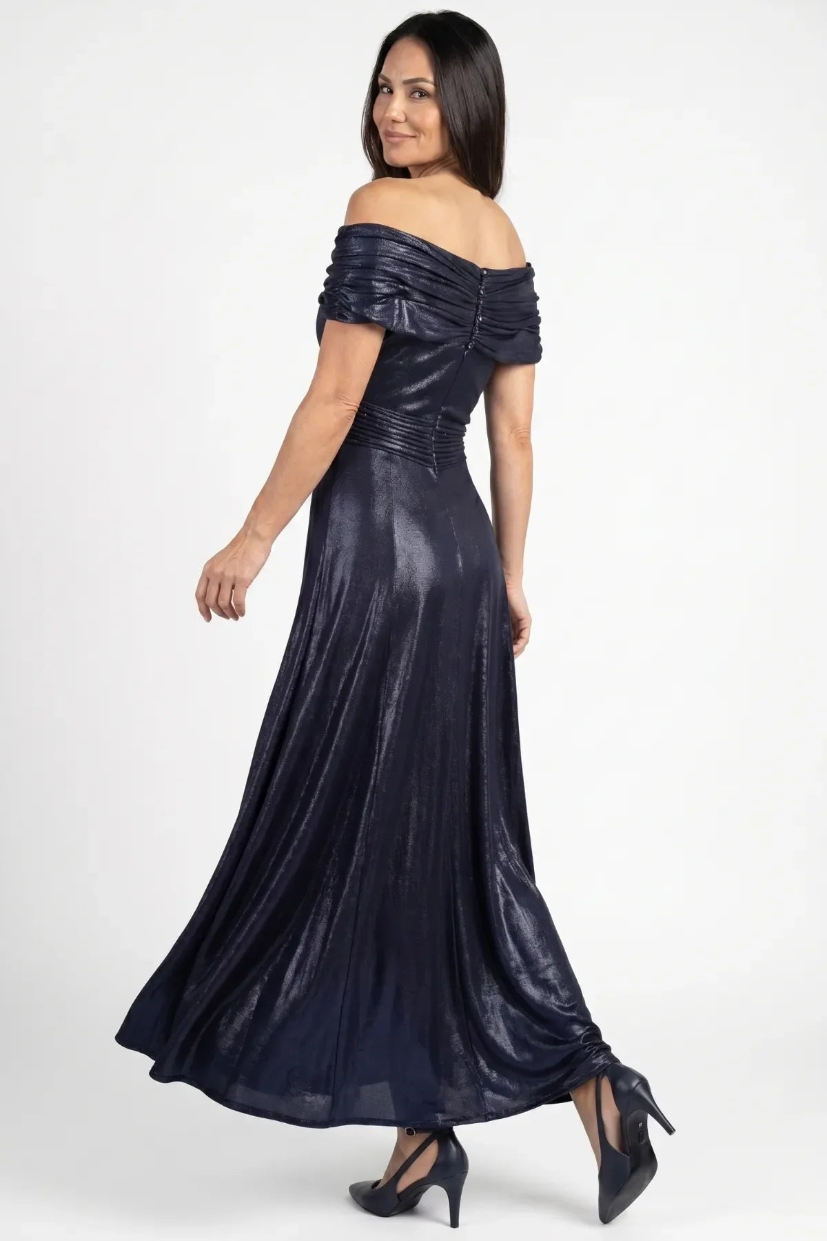 Back of navy off-shoulder gown showing covered-button bodice closure, fitted waist and long fluid skirt