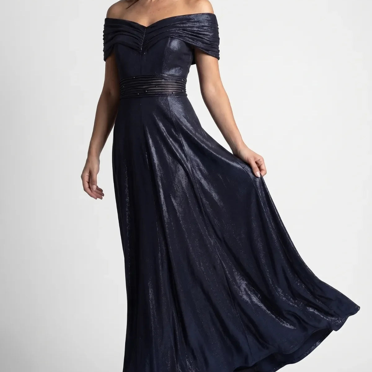 Navy Off-Shoulder Maxi Gown, Iris. Off-Shoulder Maxi Gown in navy with pleated neckline, beaded waist and flowing metallic skirt.