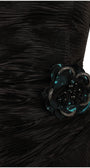 Close-up of beaded black and teal floral rosette appliqué hand-set at the waist of a ruched satin evening dress
