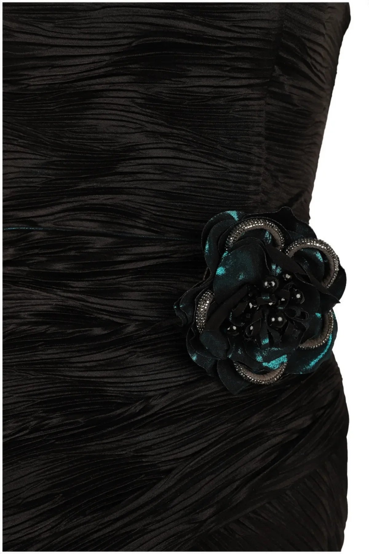 Close-up of beaded black and teal floral rosette appliqué hand-set at the waist of a ruched satin evening dress