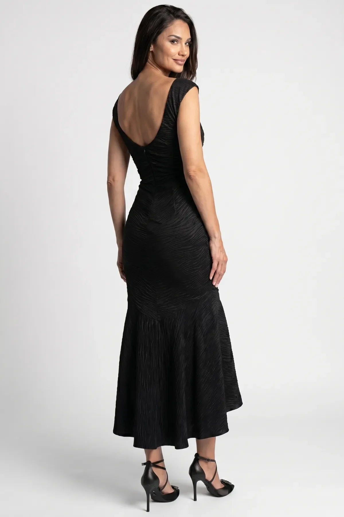 Back view of black ruched satin high low dress with deep scoop back, fitted bodice, and longer asymmetric back hem
