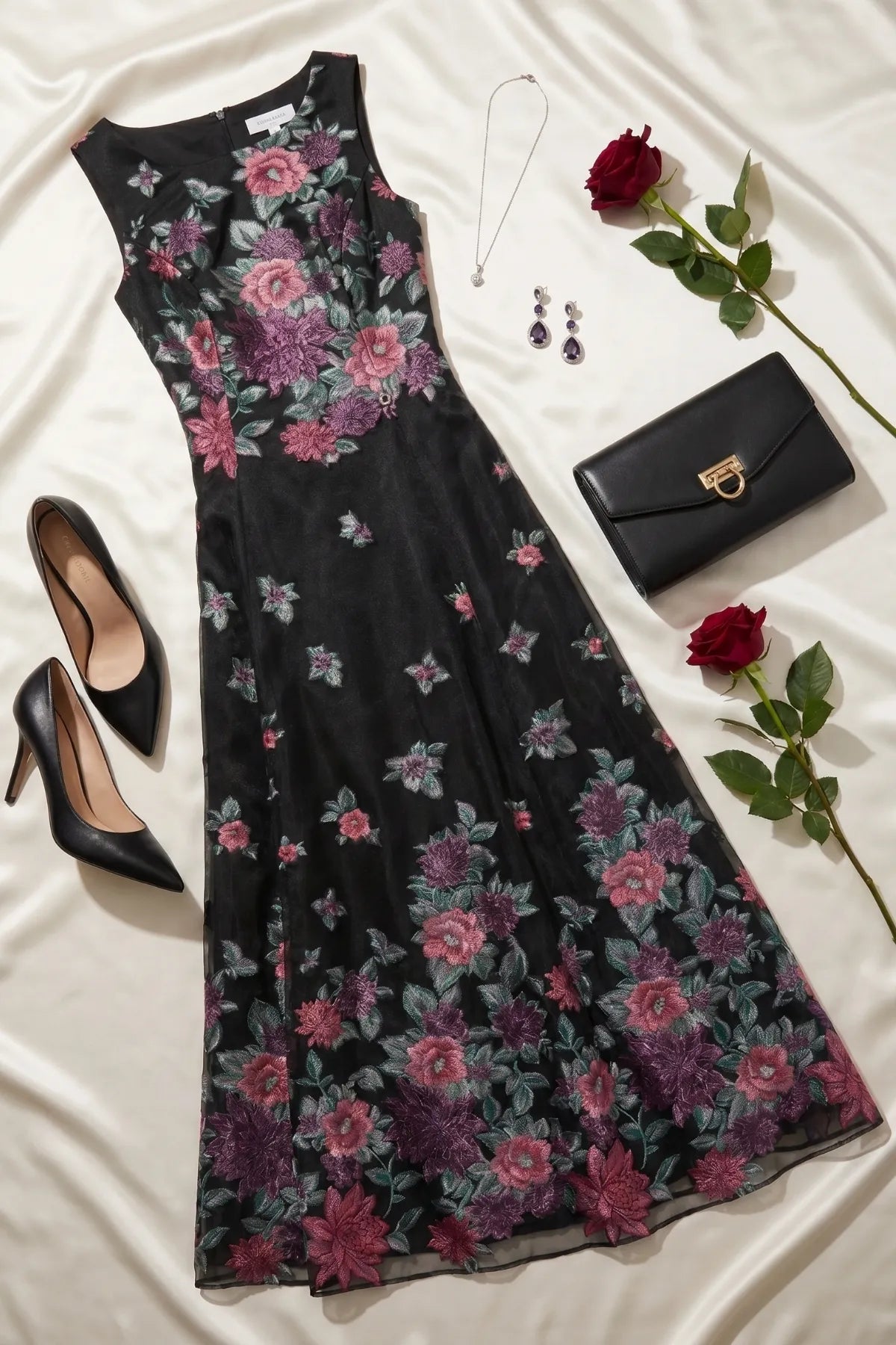 Rina cyclamen floral maxi dress styled flat with black pumps, black clutch, jewelry, and red roses.