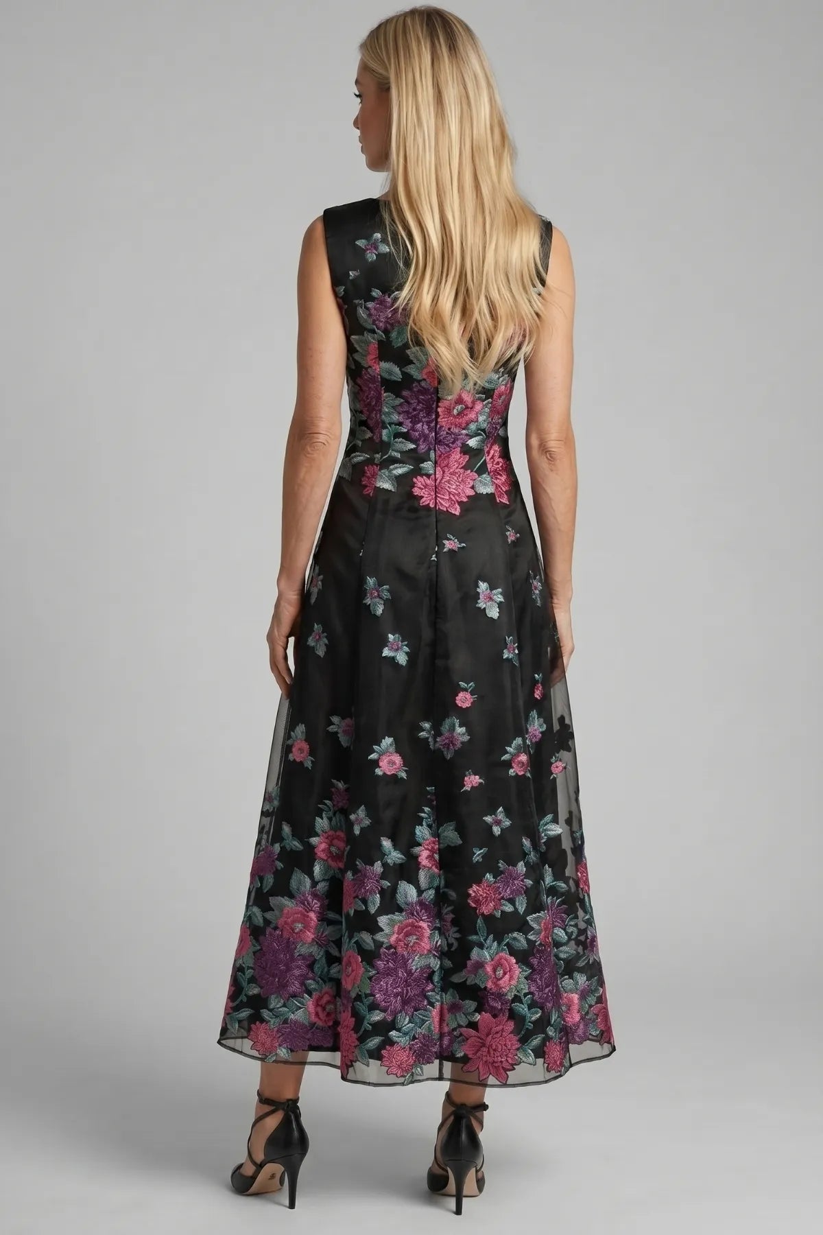 Back view of Rina cyclamen floral maxi dress showing the sleeveless bodice, back zipper, and A-line skirt.