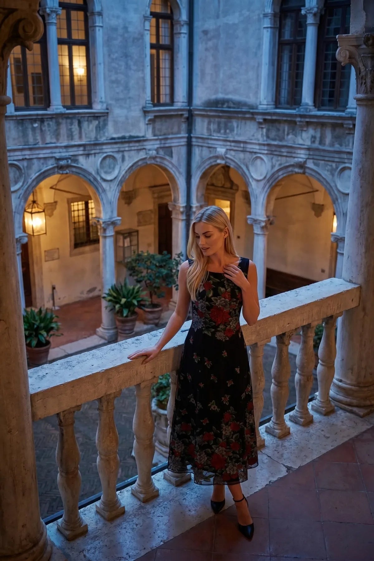 Rina black floral maxi dress in an old-world balcony setting with evening light.