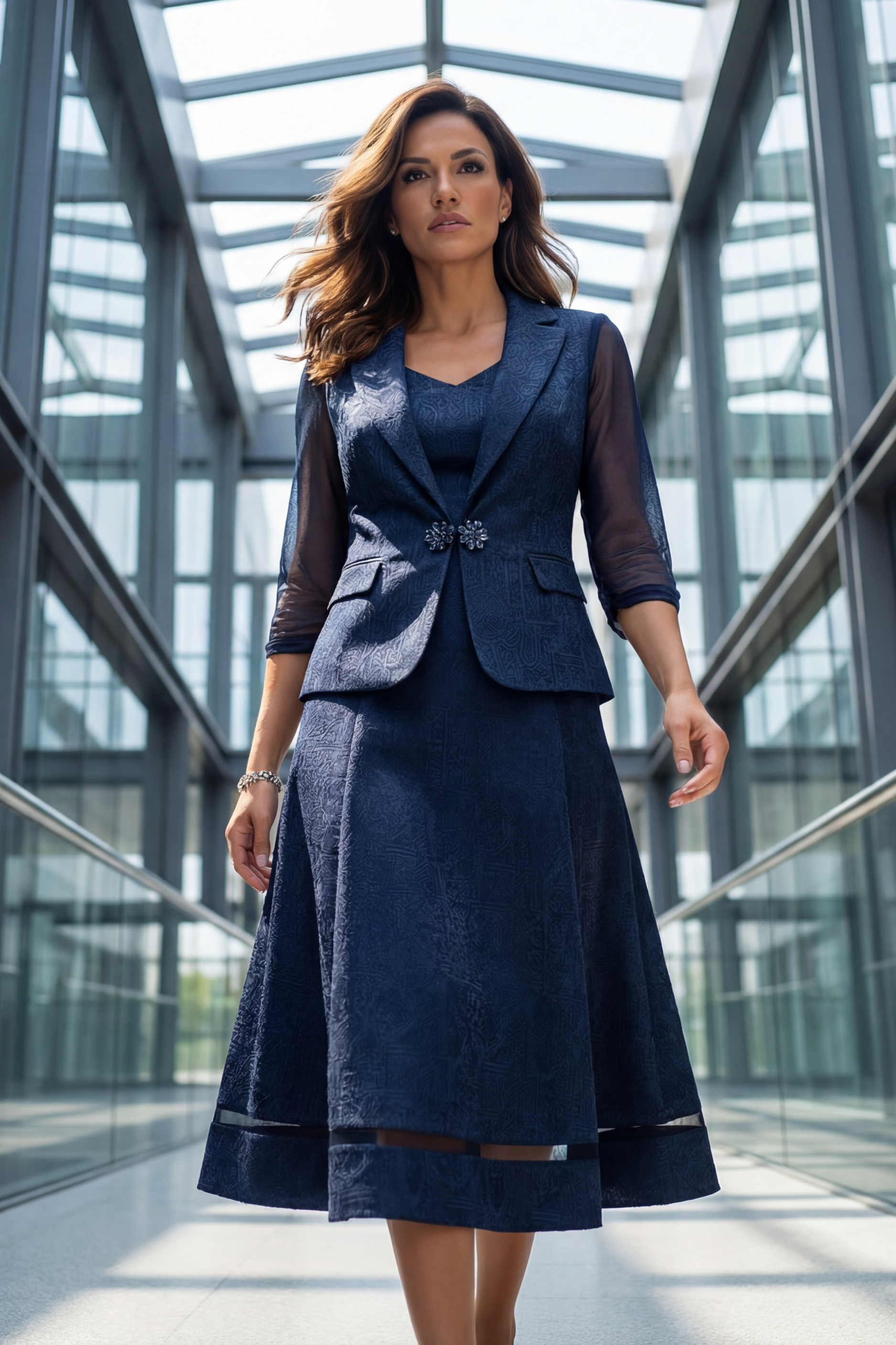 Woman in a navy blue suit standing in a modern architectural setting