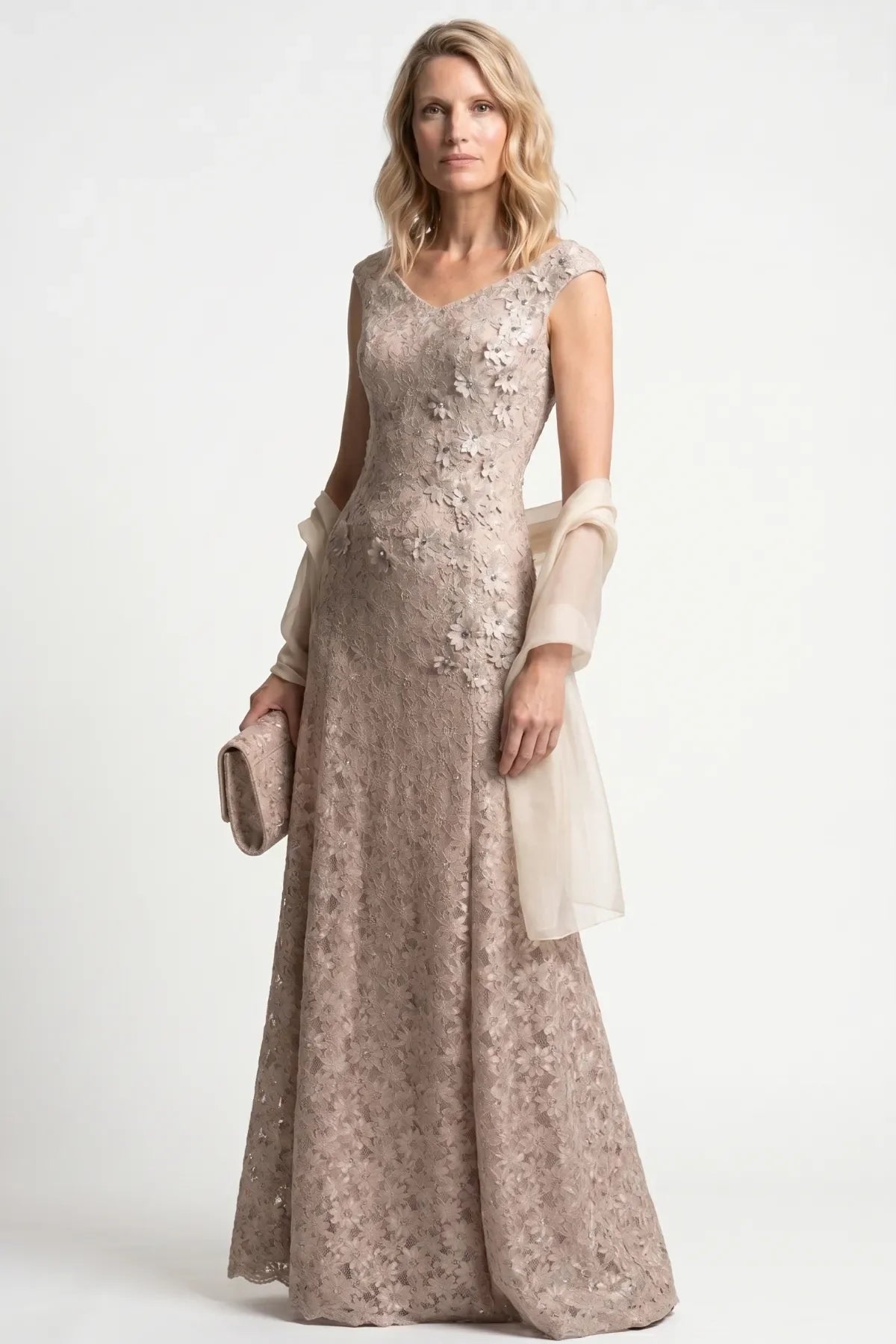 Beige lace gown styled on the model with a soft ivory wrap and matching lace clutch for evening arrival