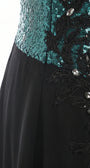 Fabric detail of teal sequins, black floral appliqué, and hand-set crystal accents over sheer black chiffon