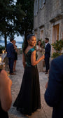 Teal and black Greta gown worn at an evening terrace celebration with candlelight