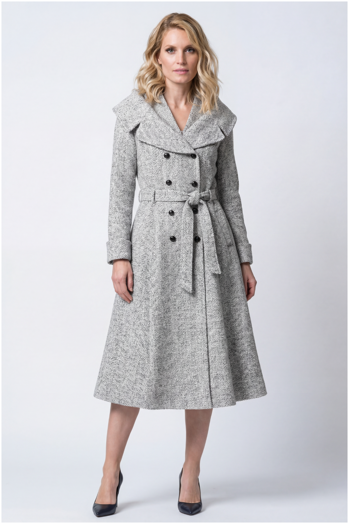 Woman wearing a gray coat with a white background