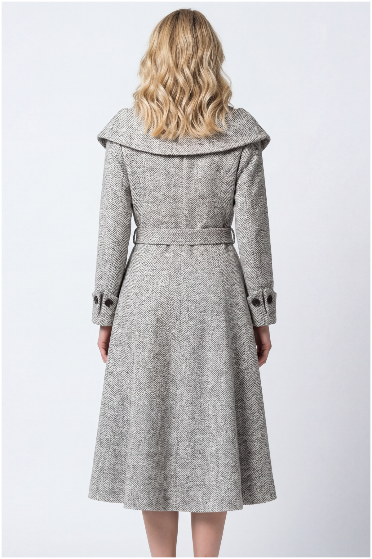 Woman wearing a gray coat on a white background