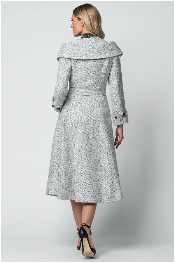 Woman wearing a gray coat with a belt on a white background