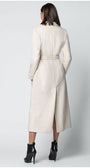 Woman wearing a long beige Luna Fashion House coat on a white background