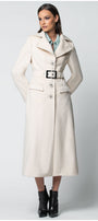 Woman wearing a long beige Luna Fashion House coat on a white background