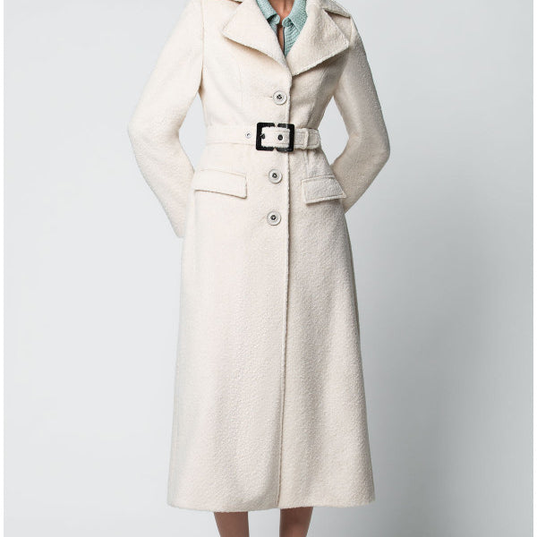 Woman wearing a long beige Luna Fashion House coat on a white background