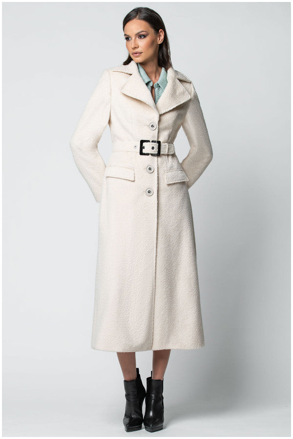 Woman wearing a long beige Luna Fashion House coat on a white background