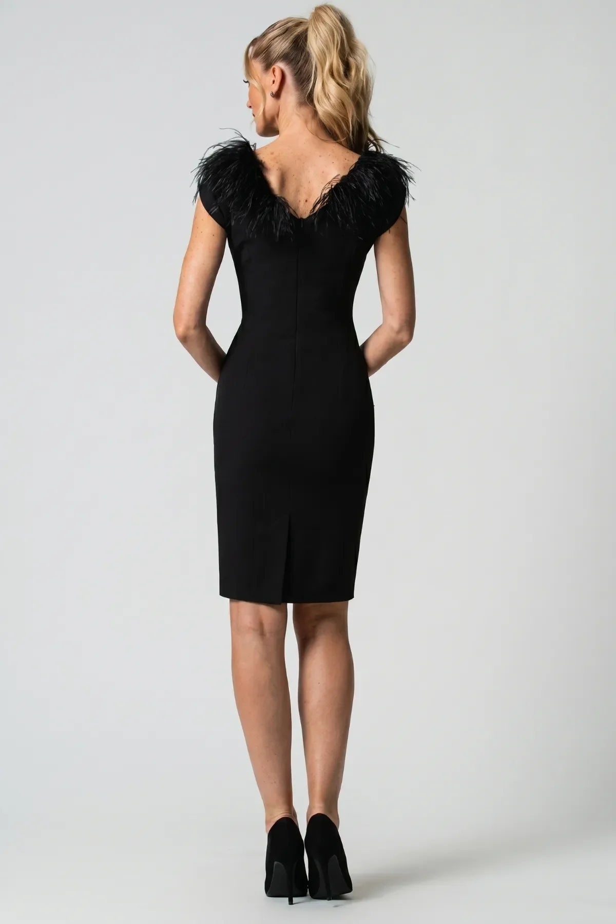Back V-neckline with feather collar wrapping the shoulders, concealed back zipper, and small center-back hem vent.