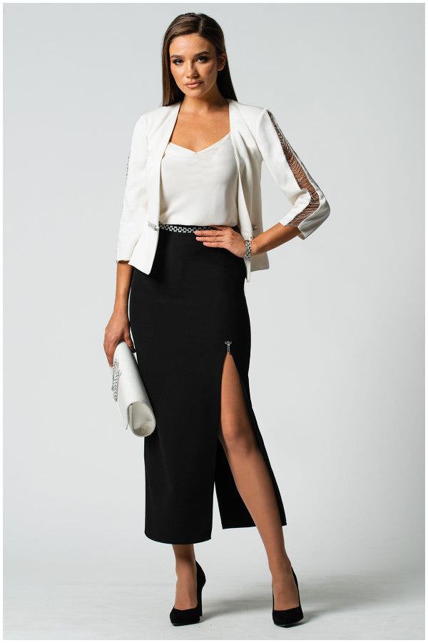Woman wearing elegant white elegant blouse Dora Blouse with jeweled straps, paired with black slit skirt and white blazer.