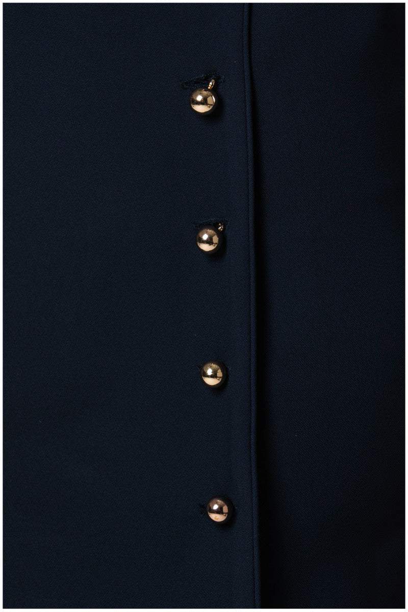 Close-up of metallic buttons on the navy wrap dress Olga by Luna Fashion House with a tailored pencil silhouette.