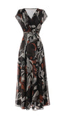 Flowing Long Dress Lola with deep V-neckline and bohemian print in earthy tones, designed for elegance and comfort.