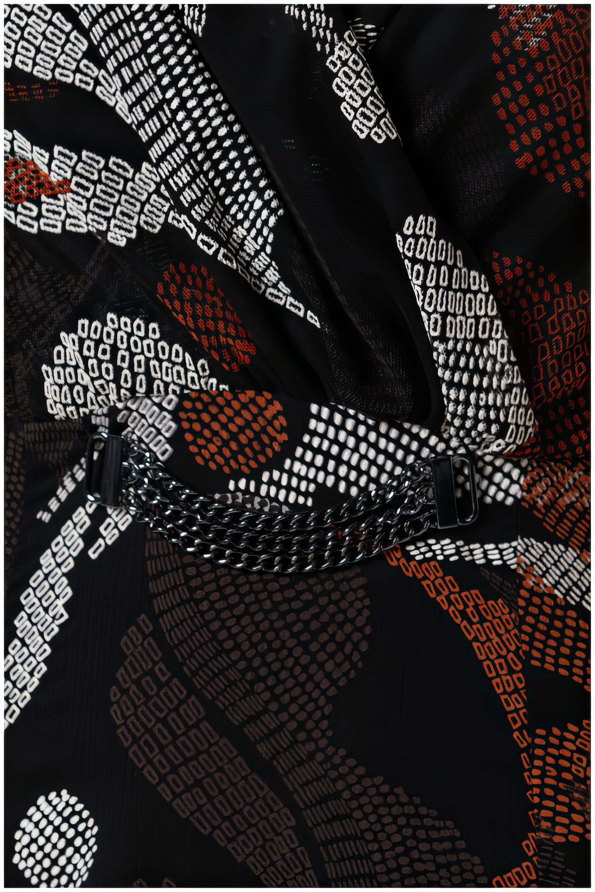 Close-up of a patterned fabric with black, white, and red colors.